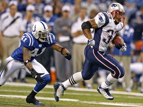 Patriots RB Kevin Faulk eludes the Colts' Antoine Bethea for some first-quarter yardage.