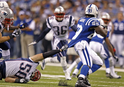 Patriots linebacker Tedy Bruschi brings down Colts RB Joseph Addai with a shirt tackle second quarter action.