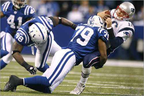 Patriots quarterback Matt Cassel was brought down by a hard hit by the Colts' Raheem Brock, as he and teammate Robert Mathis combined to bring him down as Cassel tried to scramble in the third quarter.