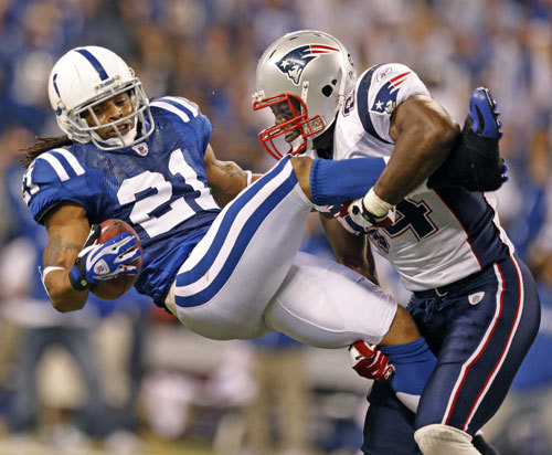 Patriots tight end Benjamin Watson and the Colts' Bob Sanders are shown as Sanders comes down with his late fourth-quarter interception.