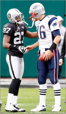Oakland Raiders defensive back Rashad Baker (left) shook the hand of New England Patriots quarterback Matt Cassel during warmups.