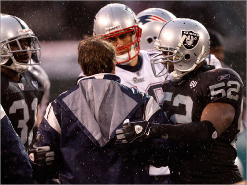 Patriots coach Bill Belichick congratulates quarterback Matt Cassel following New England's triumph over the Raiders.