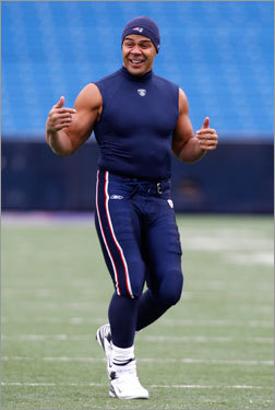 Patriots linebacker Junior Seau laughs as he is buffeted by the heavy wind gusts.