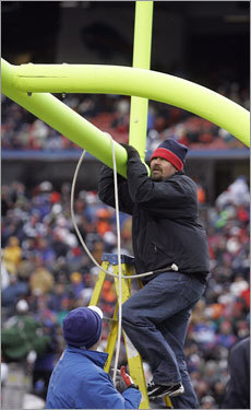 Stadium workers had to straighten a goal post before a field goal attempt during the game.