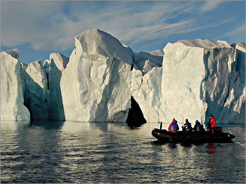 Passengers on a Zodiac boat cruise through Croker Bay during an Adventure Canada's High Arctic expedition.