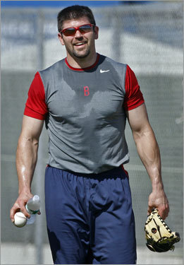 Red Sox captain Jason Varitek arrived in camp Friday, just in time to take part in the team's conditioning drills. He is shown leaving the field after the drills, drenched in sweat.