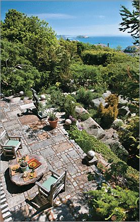 The terrace, made of locally quarried granite cobblestones, offers the perfect spot to entertain. Homeowner Andrew Spindler says it was “built like the pyramids were built, with brute strength, lots of men, rolling boulders and logs.”
