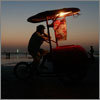 A man sells ice cream from a cart during sunset at Karachi's Clifton Beach. Photograph by Akhtar Soomro.