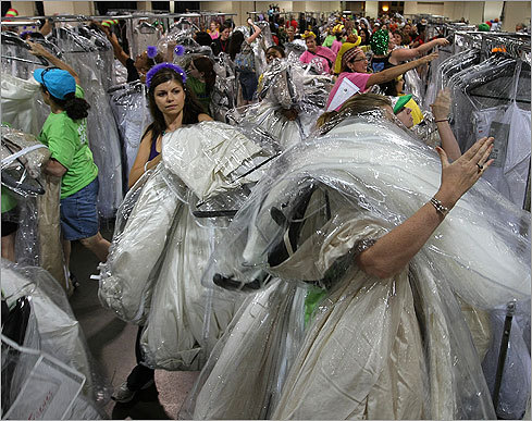 A dress-buried shopper (right) risks asphyxiation via wedding gown.