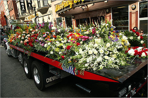 A flatbed tow truck carried some of the 190 funeral arrangements as it parked near the church on Hanover Street.