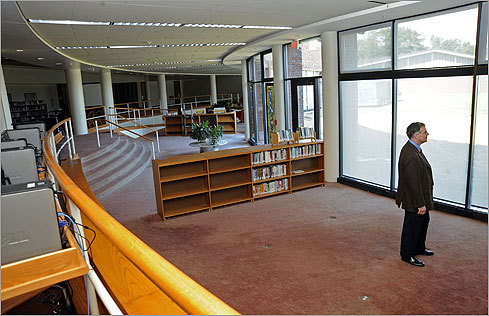 Tracy stood where, until recently, book stacks did. New computers are seen at left. 'Instead of a traditional library with 20,000 books, we’re building a virtual library where students will have access to millions of books,' said Tracy, whose office shelves remain lined with books. 'We see this as a model for the 21st-century school.'