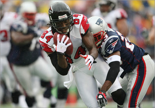 Falcons receiver Roddy White (left) hauled in a pass in front of Patriots defensive back Leigh Bodden.