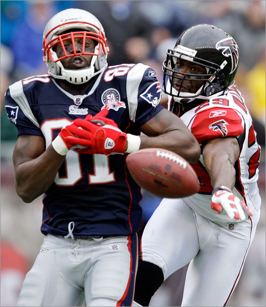 A pass intended for Randy Moss (left) was broken up by Atlanta's Brian Williams.