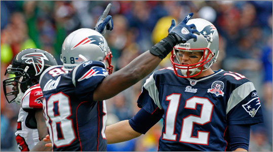 Patriots quarterback Tom Brady (right) and wide receiver Sam Aiken (center) celebrated a second quarter touchdown run by running back Fred Taylor (not pictured) that put New England ahead, 10-3.