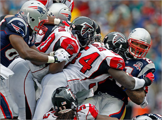 Patriots running back Fred Taylor runs into a wall of defenders.