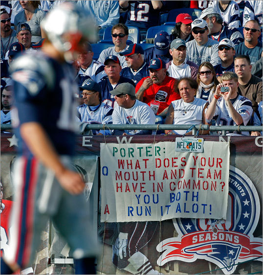 These Patriots fans had a message for Dolphins linebacker Joey Porter (not pictured) on a sign that could be seen over the shoulder of New England quarterback Tom Brady. The Patriots beat the run-happy Dolphins, 27-17, in Foxborough Sunday.