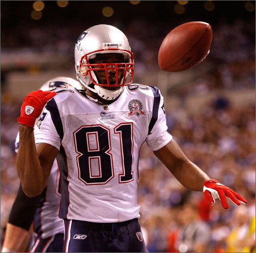 Randy Moss (81) celebrated his second touchdown catch by flipping the ball aside.