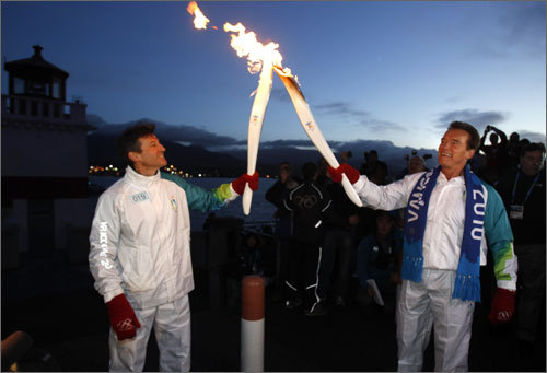 Arnold Schwarzenegger Olympic torch to London 2012 Olympic committee chairman Sebastian Coe early Friday morning in Vancouver.