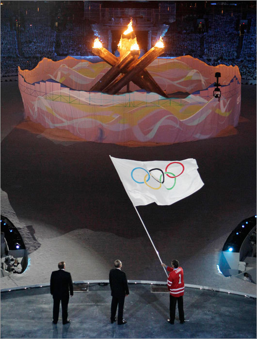 A closing ceremony tradition is the passing of the Olympic flag from the current host to the next host of the games. Gregor Robertson (right), mayor of Vancouver, waved the flag before handing off to International Olympic Committee President Jacques Rogge (center), who then gave it to the mayor of Sochi, Russia, Anatoly Pakhomov. The 2014 Winter Olympics will be held in Sochi, a resort city on the coast of the Black Sea.