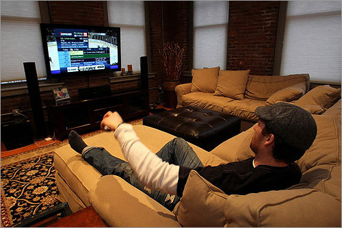 Boston Bruin defenseman Dennis Wideman has a new man cave, equipped with a pool table, an arcade-size video game and views of TD Garden. He recently refurbished his North End bachelor pad with the help of Waltham-based decorator Erin Polansky. “When I was traded here [from St. Louis], I knew I wanted to live in a place that felt like Boston,’’ Wideman says. “I like this place because it has exposed brick and beams. If I’m going to live in Boston, I want to have the full experience.' Pictured, Wideman checked out the TV selections in his condo.