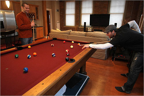 Wideman was very clear on one specific item: a pool table. He uses it two to three times a week. Wideman also had a painting by local artist Amber Ghory hung near the beloved pool table. Pictured, Boston Bruin defenseman Mark Stuart, at left, played some pool with Wideman.