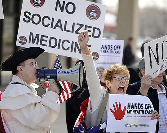 Rod Covenah (left), and Sally Sinacore shout during a tea party protest against the proposed health care plan outside the office of Rep. Melissa Bean (D-Ill.), in Schaumburg, Ill. on Tuesday, Mar. 16.
