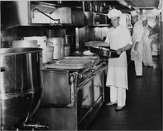 Cooks in the kitchen of St. Elizabeth Hospital in Brighton prepare 100 punds of halibut at a time in this photo from 1951.