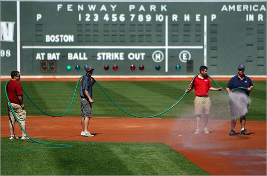 The ground crew watered down the infield Saturday in preparation for Sunday's opener against the New York Yankees.