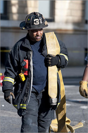 A firefighter shouldered a hose.