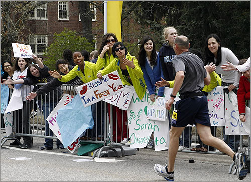 Wellesley college students cheered for runners as they raced through Wellesley.