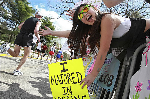 The 114th Boston Marathon rolled past the ever-enthusiastic Wellesley College students. Senior Lee Ung held a sign that said she majored in kissing.