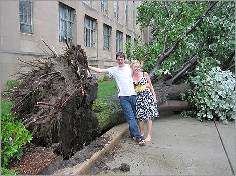 Matt Kleker and Michelle Kleker posed for a photo in front of an uprooted tree at Boston University.
