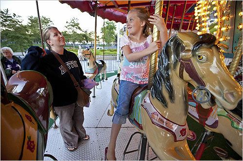 After grappling with the economy and little public interest in funding new attractions, the Greenway's latest project is funded by an anonymous donor to the Boston Foundation. In this photo, Suzette Jones of Utah and her daughter Justice, 7, took a ride on the Greenway Carousel near Columbus Park in Boston.