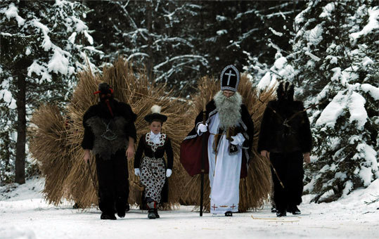 Germany On the first Sunday of the Advent season, St. Nicholas is traditionally accompanied by 12 'Buttenmandls' and a knave when they go from house to house to give small presents to the children.