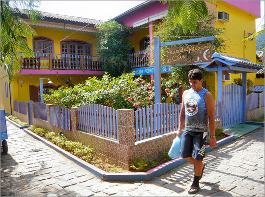 The main accommodations in town are pousada guesthouses, each painted a vibrant shade of lilac, papaya, or magenta.