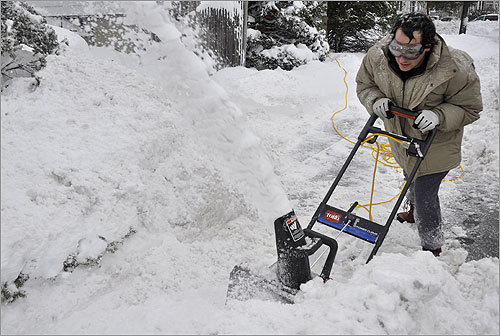 Dan Feinberg of West Roxbury used his electric snow blower to clear his sidewalk. 'I grew up in Tennessee where you just don't get this' he said.