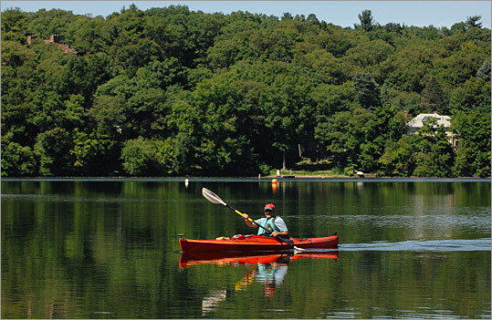 A kayaker on Upper Mystic Lake in Winchester
