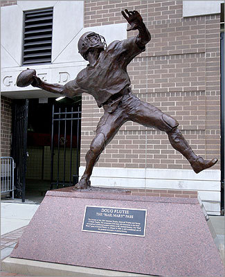 Doug Flutie The Boston College campus houses a 6-foot statue that pays homage to the quarterback whose 'Hail Mary' touchdown pass in 1984 earned him a key spot in college football history. Flutie's statue stands outside of the college's Alumni Stadium, where the Eagles play.