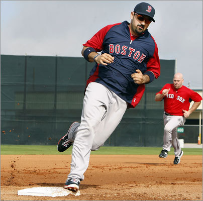 Adrian Gonzalez (foreground) and Kevin Youkilis (backround) chugged around the bases during a running drill.