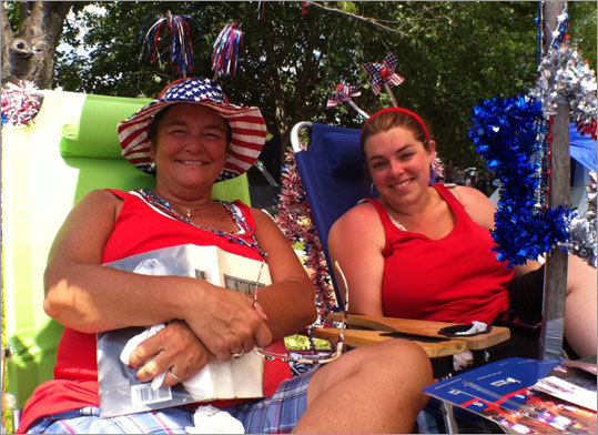 With the temperature in the mid-80s and sunny skies, Denise Gallagher, left, and her daughter, Erin, were enjoying the beautiful weather beneath an umbrella on the banks of the Charles. 'She loves [Independence Day] more than Christmas,' Erin said of her mom.