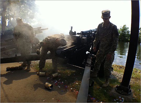 On the banks of the Charles River, members of the National Guard's Alpha 1-101 Field Artillery unit fire 105-millimeter ceremonial shells from M101 guns. The guns date to the World War II era. The shots were fired to mark Independence Day ceremonies near the Hatch Shell in Boston.
