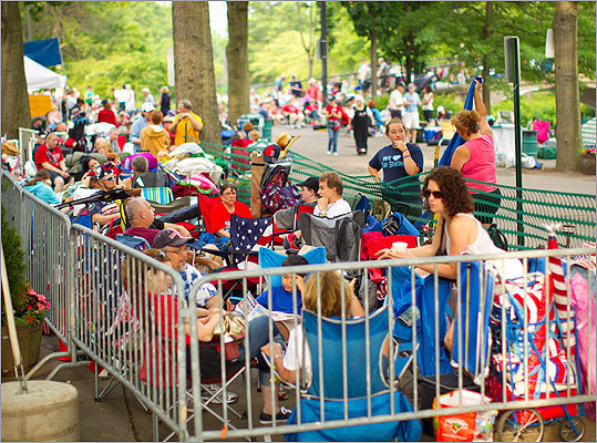 Hundreds of Fourth of July enthusiasts waited inside barricades before being allowed to claim a spot.