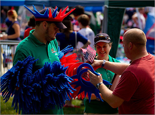 A vendor was busy selling foam Statue of Liberty crowns to people in the crowd.