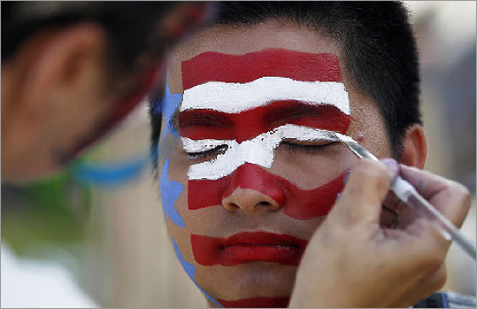 Justin D. Nguyen, of Dorchester, gets his face painted on Memorial Drive.