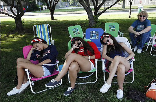 Vickie Randall, left, Erica Sousa, and Emily Lombardo fall asleep while waiting to see the fireworks in Cambridge.