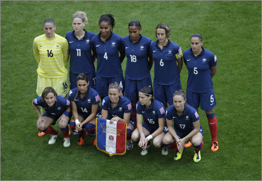 France's goalkeeper Berangere Sapowicz, Laure Lepailleur, Laura Georges, Marie-Laure Delie, Sandrine Soubeyrand, Ophelie Meilleroux, from top left, and from bottom left, Sonia Bompastor, Louisa Necib, Camille Abily, Elise Bussaglia, Gaetane Thiney line up for a team photo just before the semifinal match.