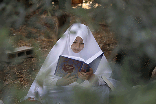 State of Palestine A Palestinian Muslim girl read from the Koran, during the month of Ramadan, in the village of Salem near the West Bank city of Nablus on Thursday. Muslims across the world are observing the holy fasting month of Ramadan.