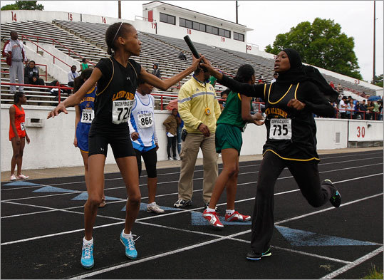 Latin Academy's girls outdoor track & field team won the Boston City League championship yesterday, besting O'Bryant which had won the championship 18 consecutive years. Latin Academy's Britney Firmin, No. 726, took the baton from teammate Imani Pressley, No. 735, during the girls' 4X400 relay at White Stadium.
