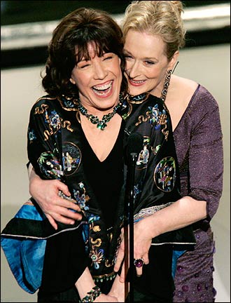 Actor and comedienne Lily Tomlin and actor Meryl Streep hugged before presenting an honorary Oscar to director Robert Altman.