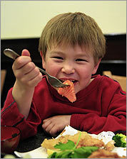 Jack Broomhead, 5, eating salmon sashimi at GinGa restaurant in Brookline.